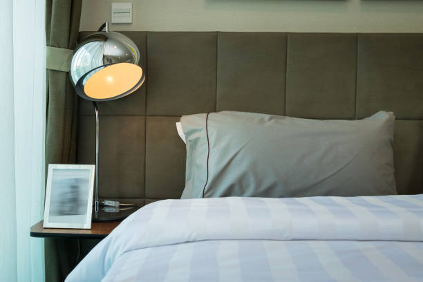 istock metal desk lamp and grey pillow on bed 827458196