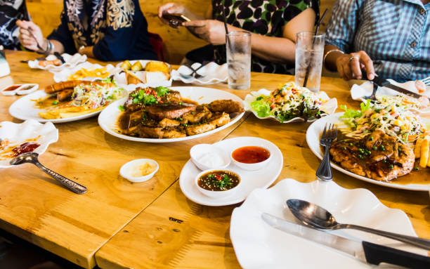 istock people meeting eating steak and salad 827458332