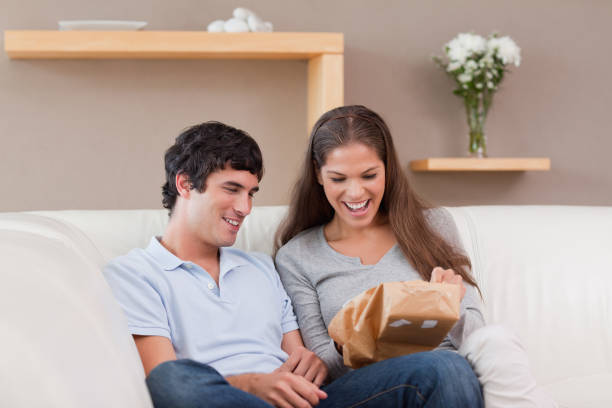 istock Couple on the couch with parcel 827464256