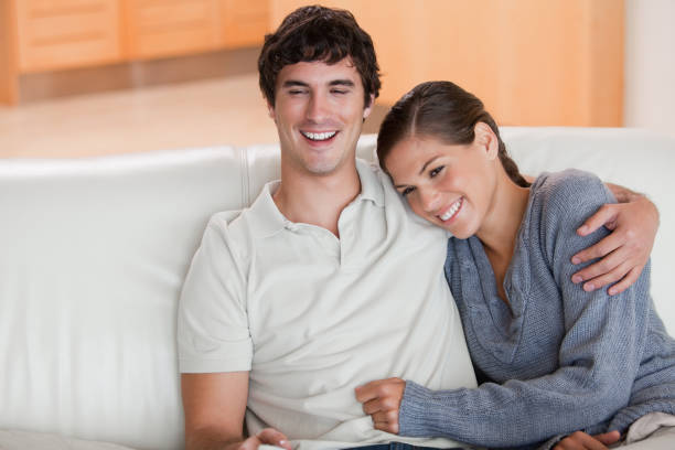 istock Happy couple enjoying their time together on the sofa 827464848
