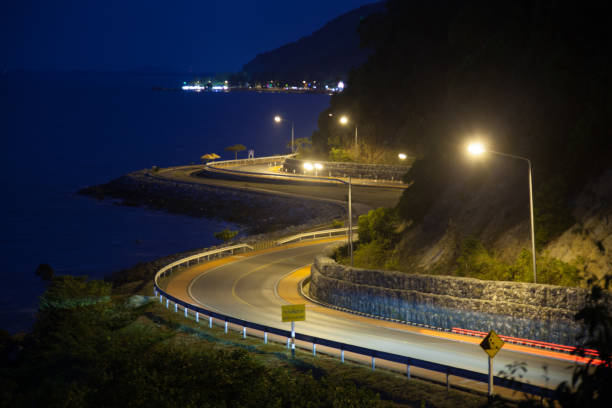 istock curved road by the sea. 827465620