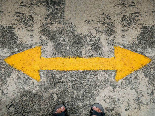 istock man stand with traffic direction arrow 827465924