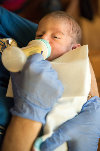istock Newborn baby being fed 827473098