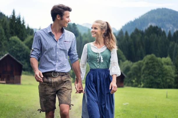 couple in traditional lederhosen and dirndl tracht, austria - dirndl traditional clothing austria traditional culture imagens e fotografias de stock