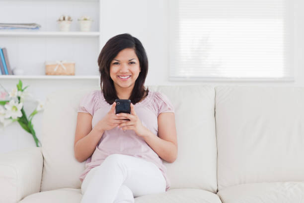 istock Woman sitting on a sofa 827473888