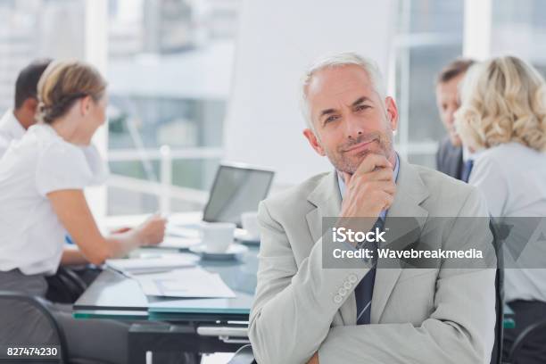 Smiling Businessman Posing In The Boardroom Stock Photo - Download Image Now - 20-29 Years, 25-29 Years, 40-44 Years