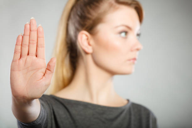 istock Female shows stop sign by her hand. 827475106