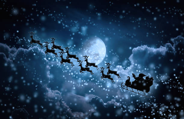 istock Silhouette of Santa Claus flying on sleigh pulled by reindeer. 827481992