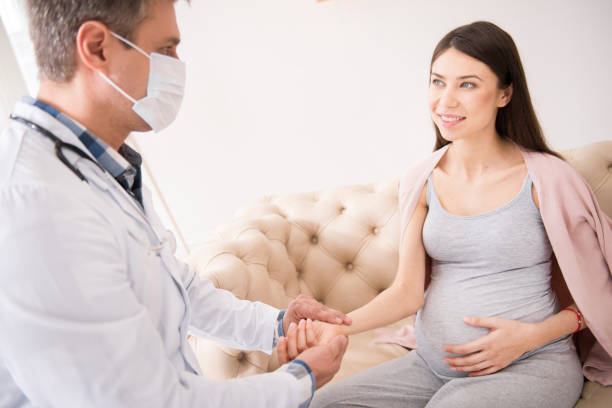istock Delighted young woman touching her belly 827482160