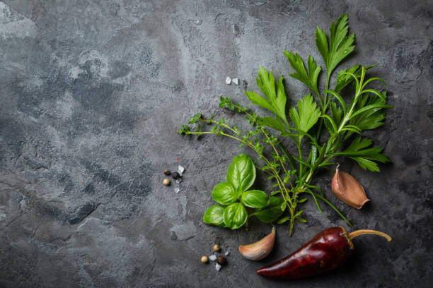 istock Selectionof herbs and spices on stone background 827482538