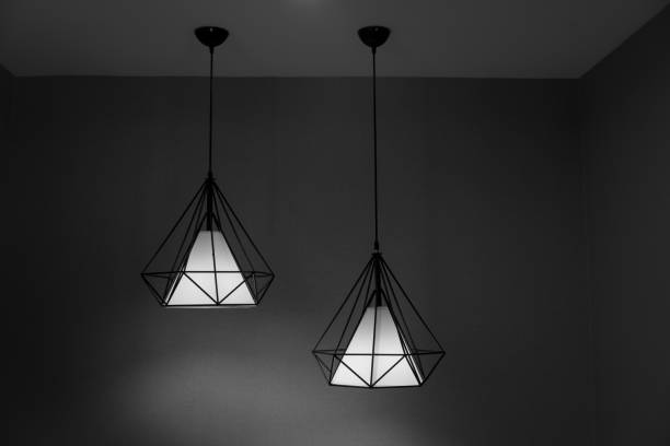 istock Two pendant lamps hanging on ceiling. 827482608