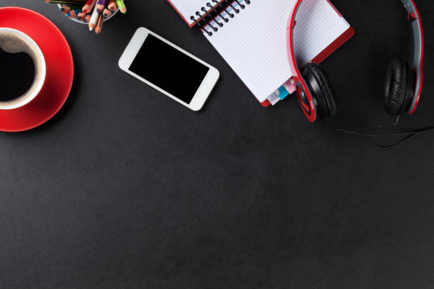 istock Desk with notepad, coffee, smartphone and headphones 827482812