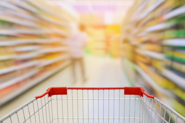 istock Supermarket aisle with empty shopping cart 827486002