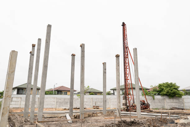istock Pile driving machine with reinforced concrete piles 827486036