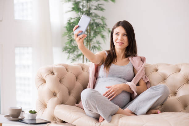 istock Attractive brunette embracing her big belly 827486166