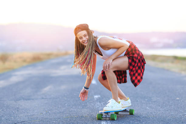 Smiling skater moving down on country road