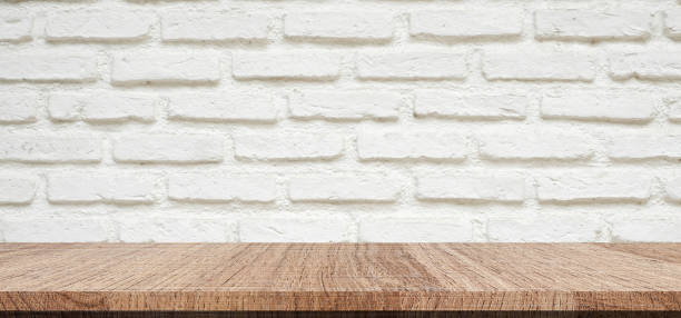 istock Empty wood table over white brick wall background, product montage display background 827487164