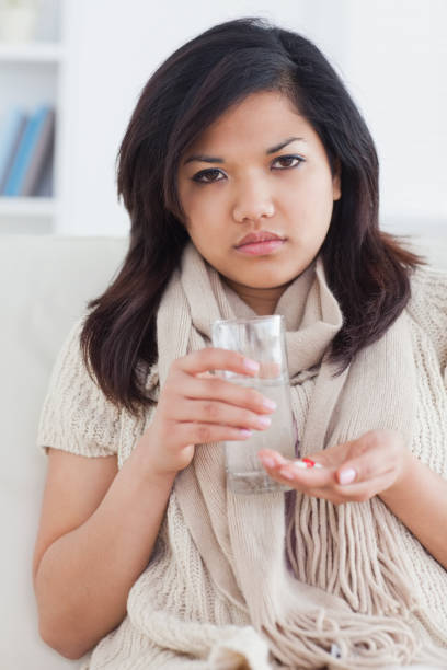 istock Sick woman taking pills 827494066
