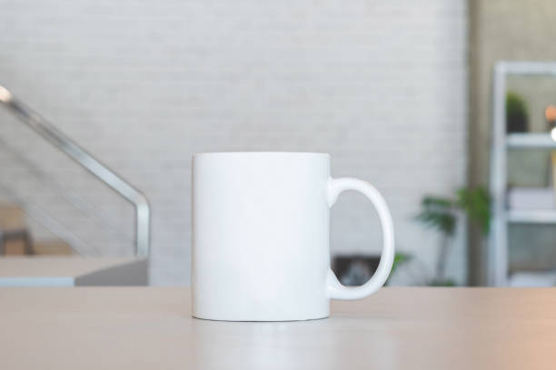 istock White mug on table and modern room background. Blank drink cup for your design. Can put text, image, and logo. 827499204