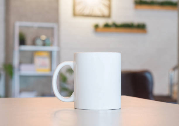 istock White mug on table and modern room background. Blank drink cup for your design. Can put text, image, and logo. 827499250