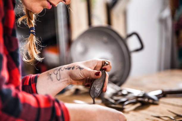 istock Young Creative Woman Creating Art with Screwing Spoons 827499612