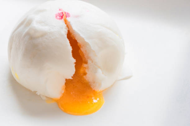 istock Steamed bun and sweet creamy stuff in white dish in selective focus. 827499700