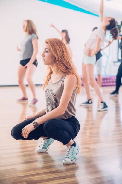 istock Teenage Girls Resting on Dance Training 827503292