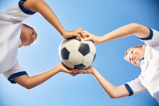 istock Boys Holding Football Ball 827507572