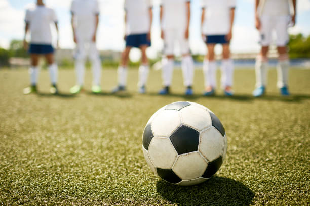 istock Ball on Grass in Junior Football Match 827507586