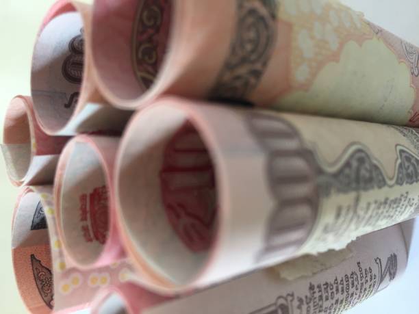 istock old rolled indian thousand(1000 )currency white background 827515408