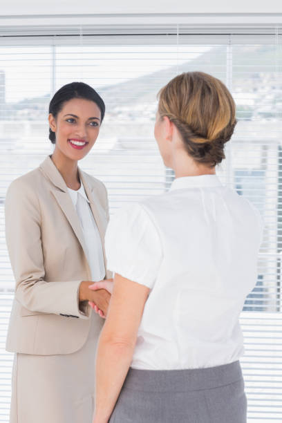 istock Attractive businesswomen shaking hands 827523354