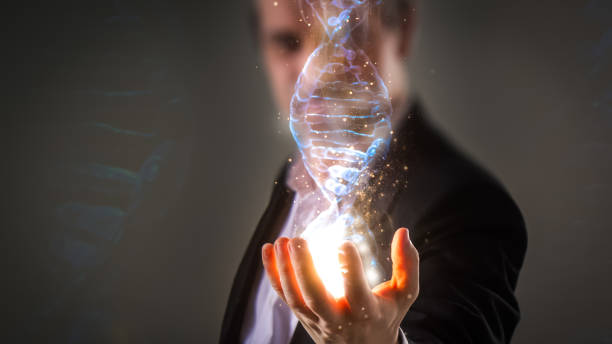 Businessman using his inner powers and holding glowing virtual DNA helix with energy sparks - business, creation, genetics, future and science concept close up of Businessman holding glowing DNA helix with energy sparks in his hands - business, creation, genetics, future and science concept crispr photos stock pictures, royalty-free photos & images
