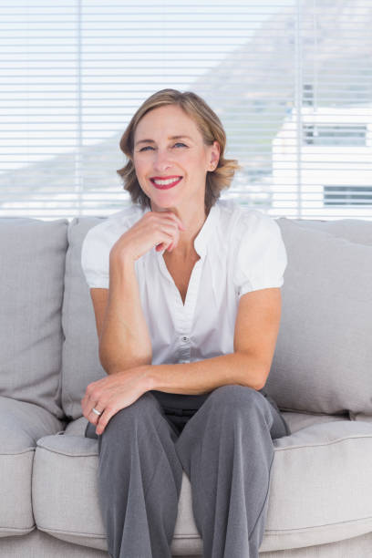 istock Confident businesswoman sitting on couch 827523614