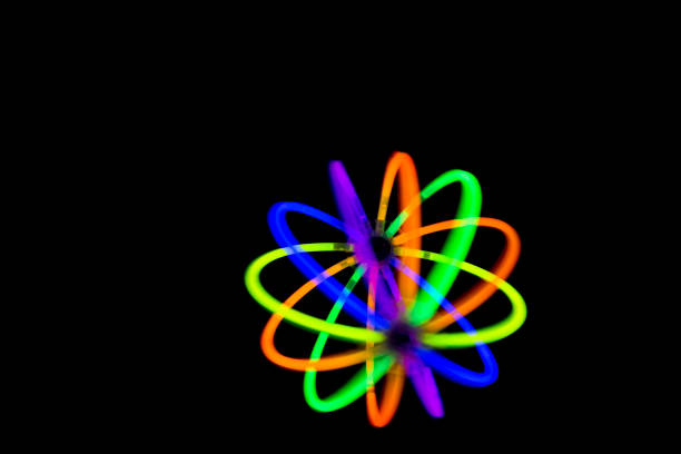 Blur ball in motion made with glow sticks neon light fluorescent on back background.