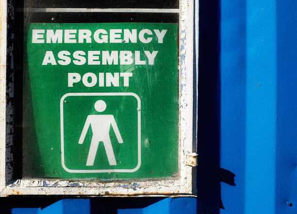 istock Emergency Assembly Point signage attached to building. 827523958