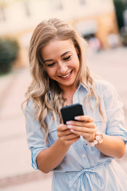 istock Woman texting outdoors 827527284