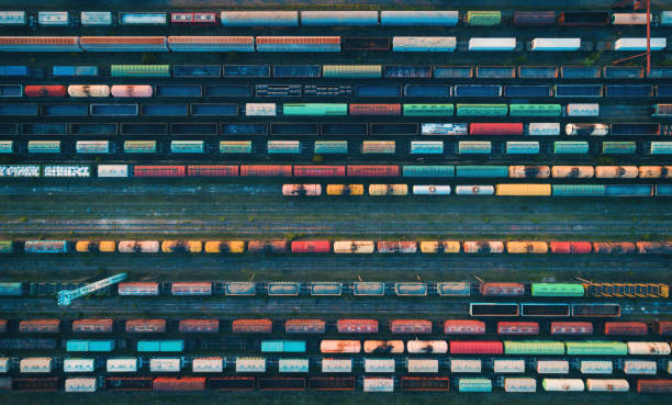 Aerial view of colorful freight trains Cargo trains close-up. Aerial view of colorful freight trains on the railway station. Wagons with goods on railroad. Heavy industry. Industrial conceptual scene with trains. Top view from flying drone freight train stock pictures, royalty-free photos & images