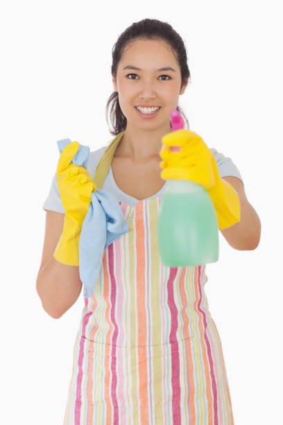 istock Smiling woman holding out spray bottle 827531336
