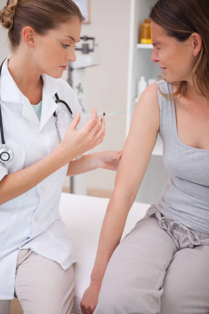 istock Patient receiving painful injection 827531464