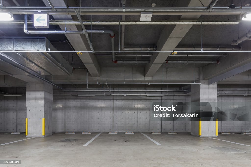 Parking garage underground interior Parking garage underground interior with neon lights Empty Parking lot Car park at underground building Parking Stock Photo