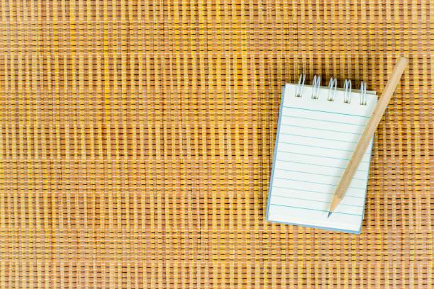 istock Notepad with pencil on wood board background. using wallpaper or background for education photo. Take note of the product for book with  paper. 827540522