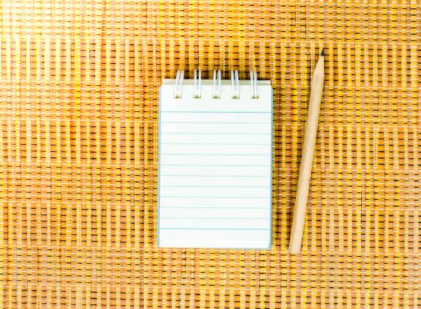 istock Notepad with pencil on wood board background. using wallpaper or background for education photo. Take note of the product for book with  paper. 827540536