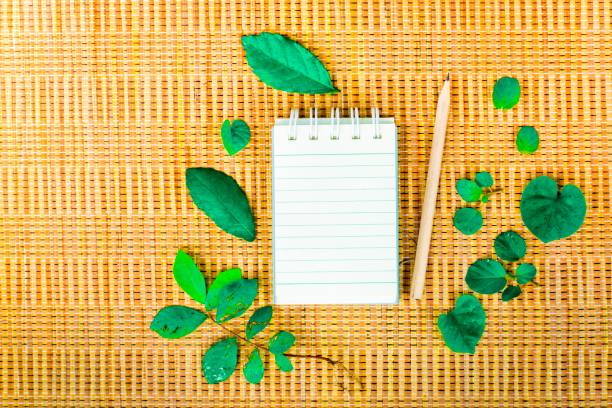 Notepad with pencil on wood board background. using wallpaper or background for education photo. Take note of the product for book with  paper.