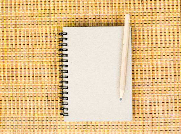 istock Notepad with pencil on wood board background. using wallpaper or background for education photo. Take note of the product for book with  paper. 827540606