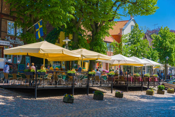 People dining at outside restaurant. The scene is Am Markt in Burg on the Fehmarn island at the Baltic Sea