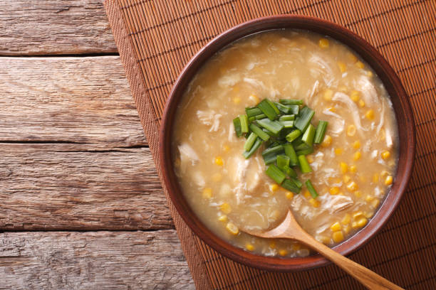 Chinese corn and chicken soup in a bowl close-up. horizontal top view stock photo