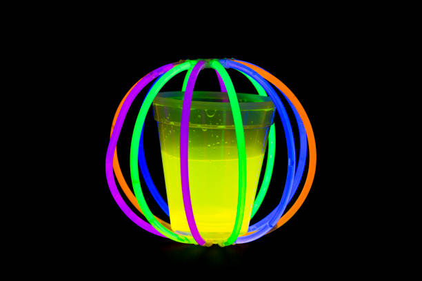 istock Yellow colored fluorescent glass with glow sticks lights 827546056