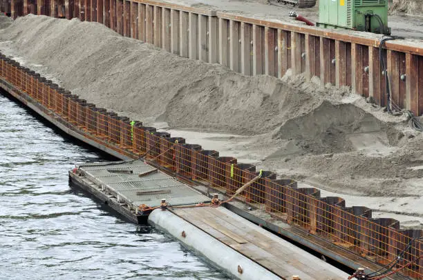 Photo of The process of construction of the embankment. Installation of metal formwork and mound.