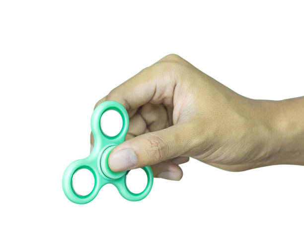 istock Hand holding fidget spinner isolated on white background. Stress relieving toy. 827549930