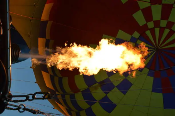A hot air balloon is fired up for an early morning flight over Queenstown